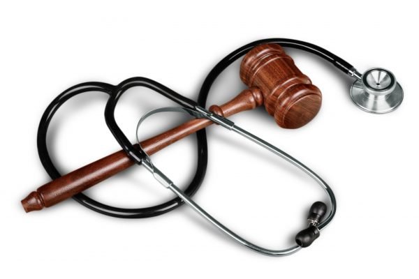 Gavel and stethoscope  on background, symbol photo for bungling and medical error